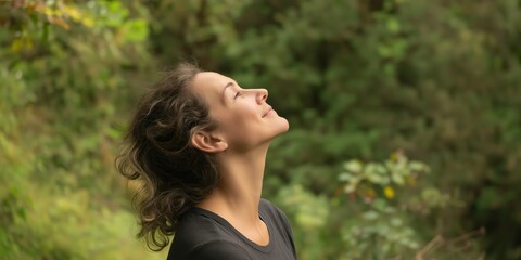 Obraz premium A woman is peacefully enjoying a moment in nature, embracing tranquility and connection with the environment, while reflecting on personal thoughts and emotions.