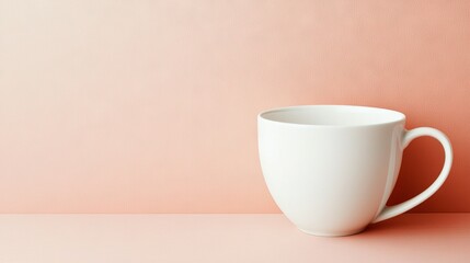 Fototapeta premium A white coffee cup atop a table next to a pink wall and a pink background