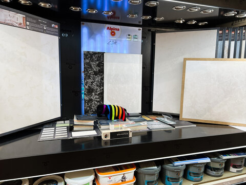 Kyiv, Ukraine - January 10, 2025: Display of decorative paint textures in a store with lighting showcase