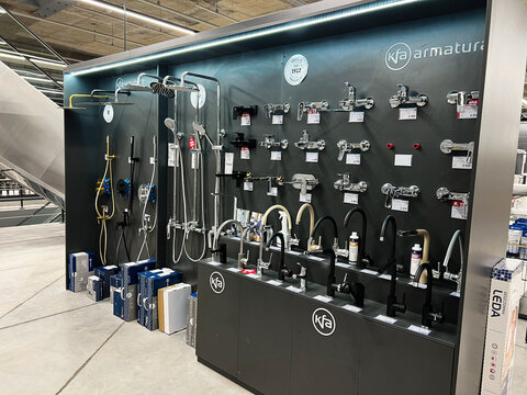 Kyiv, Ukraine - January 10, 2025: Display of modern faucets and shower fittings in a showroom interior