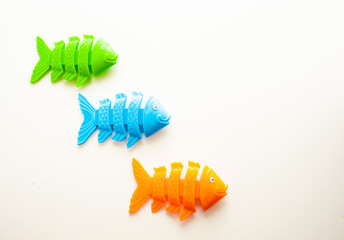 Plastic fish skeletons in green, blue and orange color.