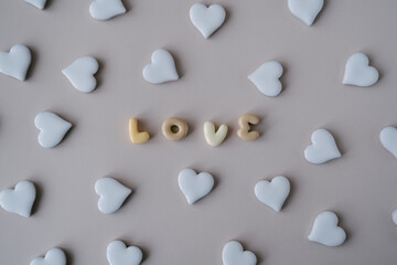 An arrangement of white ceramic hearts surrounding the word 