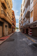 Narrow street with buildings very close to each other, blocking sunlight from entering for long periods, in the municipality of Torrenueva Costa, Granada, Andalusia.