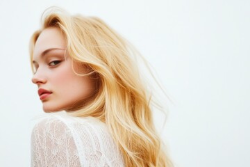 A woman with long blonde hair wearing a white shirt, suitable for editorial or commercial use