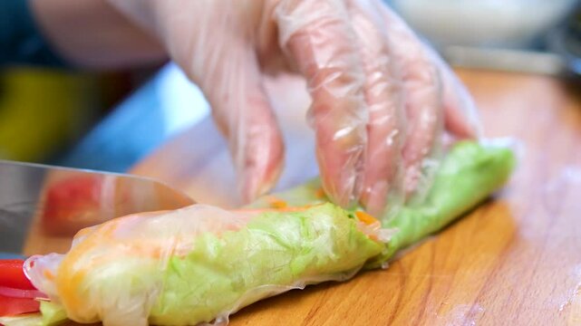 Spring roll with chicken or shrimps in rice paper with sweet and sour sauce close-up, cooking traditional korean chinese food. Tasty vietnamese cuisine.
