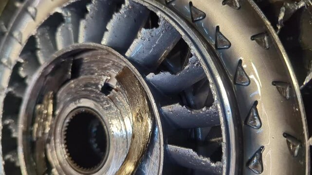 Metal debris from a destroyed turbine wheel in the torque converter of a car's automatic transmission, professional repair at an auto service.