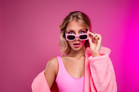 Photo of attractive young woman model amazed taking off sunglass wear christmas fur coat isolated pink color background