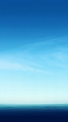 Obraz premium A vertical background featuring a clear blue sky, perfect for serene, natural, and uplifting themes. Ideal for designs, wallpapers, and creative projects.