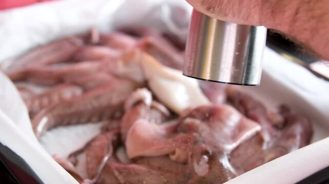 octopus black pepper Fresh raw sea food lying on ice counter in fish market. Open shelf with octopus, shrimps and squids on seafood store. Close up