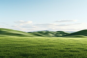 Lush green rolling hills under a clear blue sky in a tranquil landscape during daytime