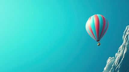   Hot air balloon flying on snowy mountaintop against clear blue sky