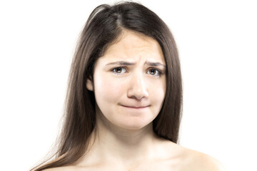 Fototapeta premium Close-up portrait of a young woman with a confused expression on a white background