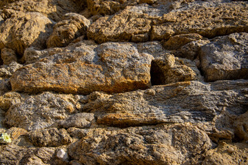 Stones texture of a medieval castle wall. Dry stone pattern of an ancient building made of rocks
