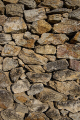 Stones texture of a medieval castle wall. Dry stone pattern of an ancient building made of rocks