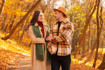 Happy couple spending time together in autumn park