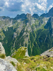 Breathtaking mountainous view with lush green peaks under a vivid blue sky