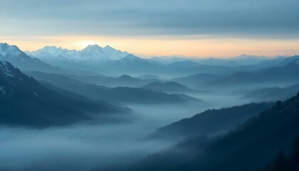 Fototapeta premium Layered misty mountains at sunrise with golden hues and serene, tranquil atmosphere.
