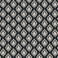 Elegant cream and black damask seamless pattern. Vintage baroque floral motif ideal for wallpaper, textiles, backgrounds, and luxury decorative design.