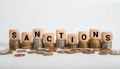Sanctions Concept with Word Reflecting on Wooden Surface