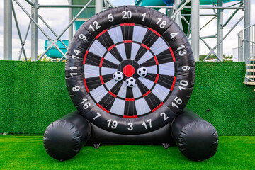 A large inflatable target with a red bullseye and a soccer ball in the center