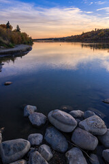 A beautiful lake with a sunset in the background