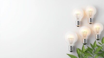 Illuminated light bulbs with green leaves on white background