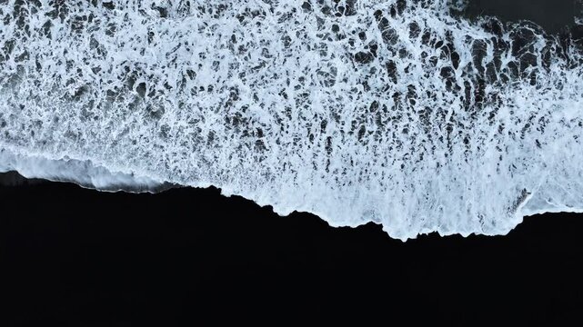 Black sand beach with crashing waves, Serene and tranquil landscape, Ocean coast with calm waves, Famous landmark of Iceland, Black sand of volcanic origin aerial view