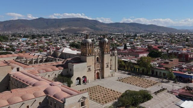 day flying counter clockwise around plaza in front of Templo de Santo Domingo in Oaxaca