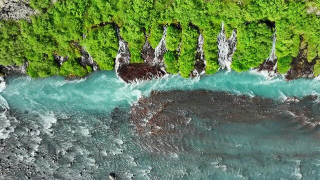 Pure river with many small waterfalls, Stunning bird's eye view, Cold turquoise glacial river with many streams in summer season, Iceland, Hraunfossar and Barnafoss