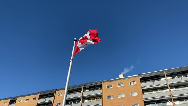 Canadian Flag Flying Near Residential Building