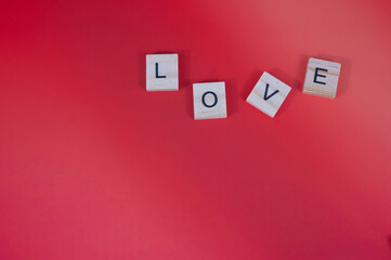 Red hearts and candles on red background with lighting love you letters word text 