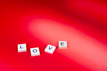 Red hearts and candles on red background with lighting love you letters word text 