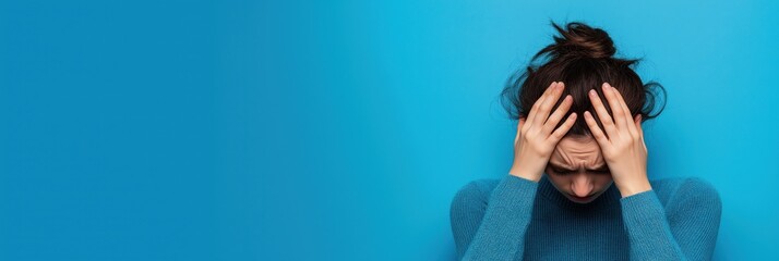 A woman visibly overwhelmed with emotion, holding her head in stress, encapsulating the essence of mental health struggles and the importance of support and understanding.