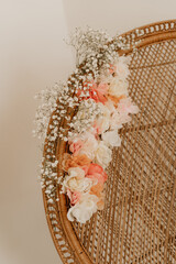 Peacock chair with pink and white wedding flowers from a style shoot