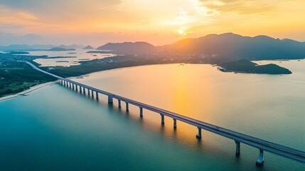 Obraz premium Long bridge spans serene coastal waters at sunset