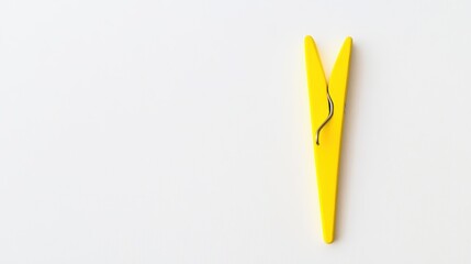 Yellow Clothespin on a White Background