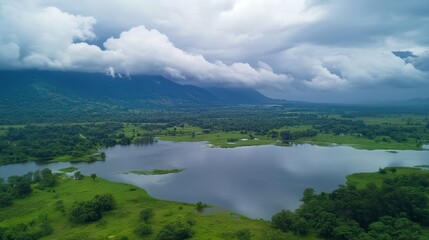 Naklejka premium Serene landscape with lush greenery and tranquil lake under cloudy skies