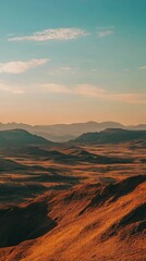 Naklejka premium Expansive Desert Landscape with Rolling Hills and Distant Mountains