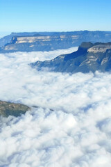 Thick morning fog, creating a mysterious atmosphere. Stylized cinematic mountain landscape