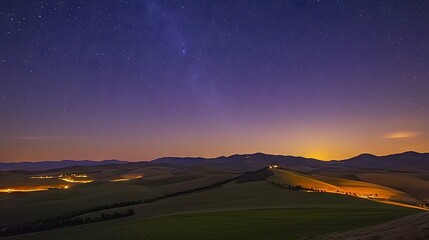 A dreamy starlit sky over a rural landscape with fields and hills.