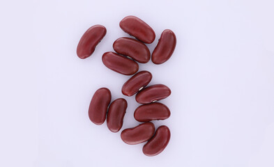 A pile of black beans flat lay on white background. Top view showing a pile of black beans in isolated on white background.