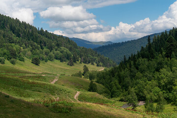 The valley of the Malaya Dukka River surrounded by the mountains of the North Caucasus and the tourist trail to the Dukka Lakes on a sunny summer day, Arkhyz, Karachay-Cherkessia, Russia © Ula Ulachka