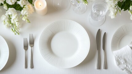 minimalist scandinavian table setting, pure white plates, sleek metallic flatware, fresh white delphiniums, ribbed glass votive candle, wine goblets, pale neutral surface, ethereal light, aerial view