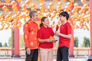 portrait happy asian family with worship things in chinese shrine,concept for holiday celebration,chinese new year traditional
