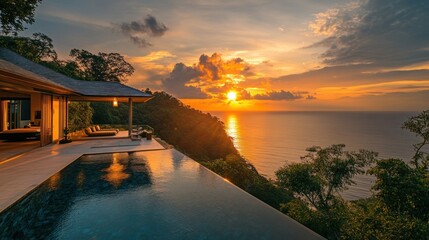 Fototapeta premium Sunset over ocean view from infinity pool villa.