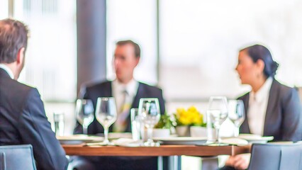 Executive Dinner Blur &ndash; A soft-focus background of an executive dinner with formal discussions taking place.	
