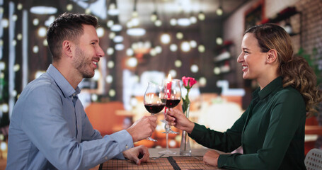 Portrait Of Romantic Couple Toasting Red Wine
