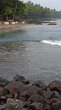Side View of Ocean Waves Rolling Toward Anyer Beach Shoreline