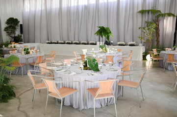 wedding table setting for wedding and dinner with family and relatives. Flower arrangement as a centerpiece on top of the dinner table