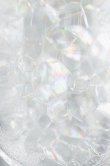 close-up of soap detergent bubbles inside glass bottle container